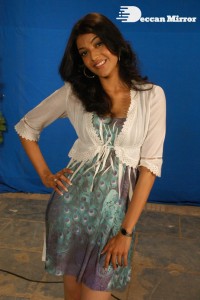 Actress Kajal Aggarwal in a green dress and a white coat