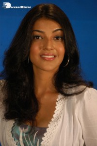 Actress Kajal Aggarwal in a green dress and a white coat