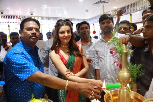 Bollywood and Telugu Actress Kajal Aggarwal in a green saree at a store opening function