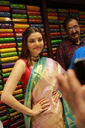 Bollywood and Telugu Actress Kajal Aggarwal in a green saree at a store opening function