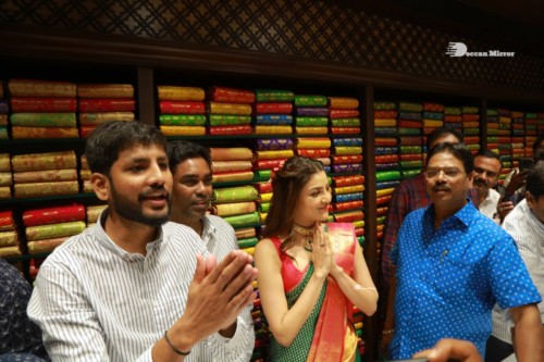 Bollywood and Telugu Actress Kajal Aggarwal in a green saree at a store opening function