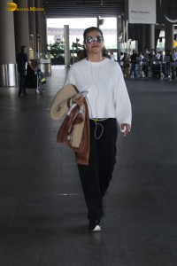 actress kajol chic look in a white top at airport