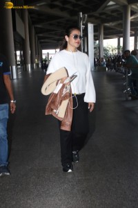 actress kajol chic look in a white top at airport