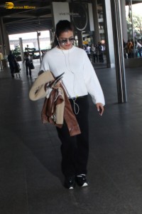 actress kajol chic look in a white top at airport