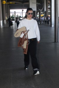 actress kajol chic look in a white top at airport