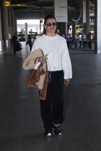 actress kajol chic look in a white top at airport