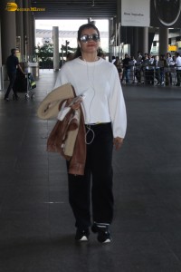 actress kajol chic look in a white top at airport