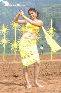 Actress Kamna Jethmalani in a yellow dress during a film shoot