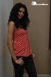 Kamna Jethmalani in a white dotted orange top and jeans