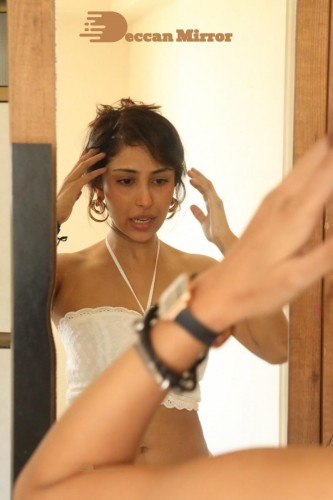 Bollywood and Telugu Cinema Actress Kapilakshi Malhotra posing for hot pictures in a white dress in front of mirror