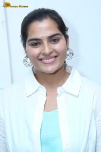 Indian Actress Kavya Kalyanram in a white shirt and blue skirt