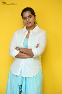 Indian Actress Kavya Kalyanram in a white shirt and blue skirt