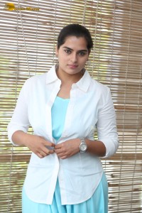 Indian Actress Kavya Kalyanram in a white shirt and blue skirt