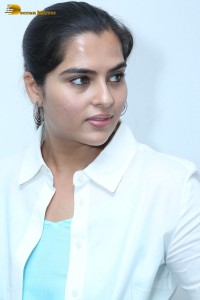 Indian Actress Kavya Kalyanram in a white shirt and blue skirt
