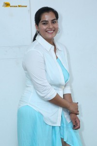 Indian Actress Kavya Kalyanram in a white shirt and blue skirt
