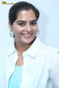 Indian Actress Kavya Kalyanram in a white shirt and blue skirt