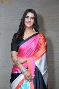 actress Kavya Thapar in a black and pink saree