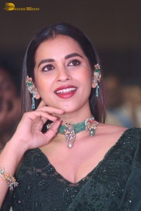 Telugu Actress Komalee Prasad in a green saree attending HIT 2 pre-release function