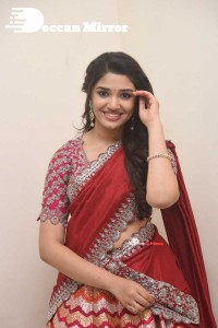 Actress Krithi Shetty in a red color half saree