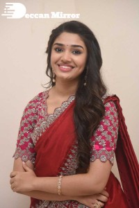 Actress Krithi Shetty in a red color half saree