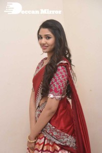 Actress Krithi Shetty in a red color half saree