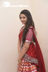 Actress Krithi Shetty in a red color half saree