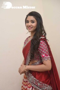 Actress Krithi Shetty in a red color half saree