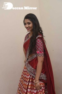 Actress Krithi Shetty in a red color half saree