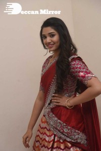 Actress Krithi Shetty in a red color half saree