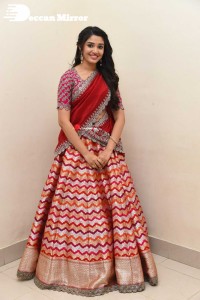 Actress Krithi Shetty in a red color half saree