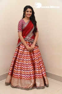 Actress Krithi Shetty in a red color half saree