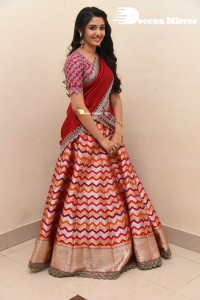 Actress Krithi Shetty in a red color half saree