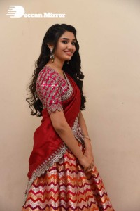 Actress Krithi Shetty in a red color half saree