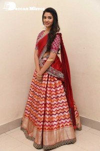 Actress Krithi Shetty in a red color half saree