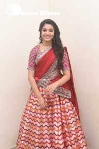 Actress Krithi Shetty in a red color half saree