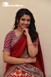 Actress Krithi Shetty in a red color half saree