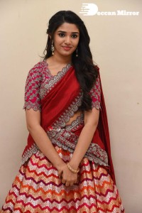 Actress Krithi Shetty in a red color half saree