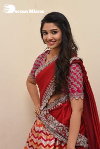 Actress Krithi Shetty in a red color half saree