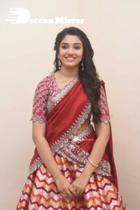 Actress Krithi Shetty in a red color half saree