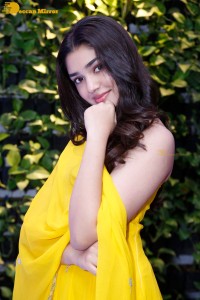 Actress Kirthi Shetty in a yellow salwar dress