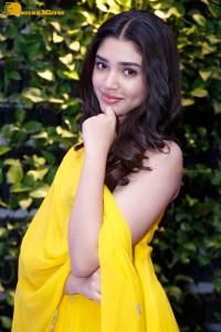 Actress Kirthi Shetty in a yellow salwar dress