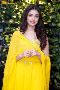 Actress Kirthi Shetty in a yellow salwar dress