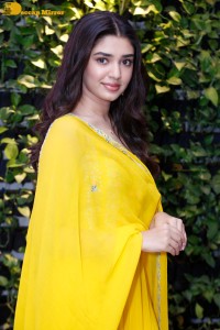Actress Kirthi Shetty in a yellow salwar dress