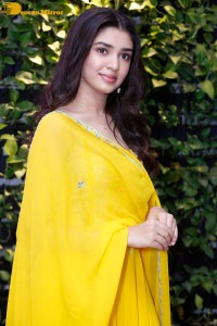 Actress Kirthi Shetty in a yellow salwar dress