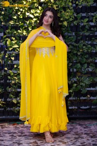 Actress Kirthi Shetty in a yellow salwar dress