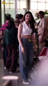 telugu actress Krithi Shetty cute in a white top and blue denim jeans