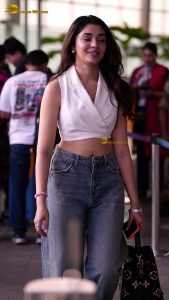 telugu actress Krithi Shetty cute in a white top and blue denim jeans