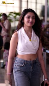 telugu actress Krithi Shetty cute in a white top and blue denim jeans