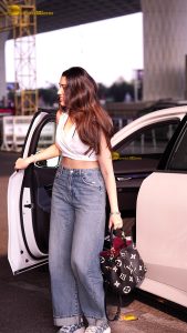 telugu actress Krithi Shetty cute in a white top and blue denim jeans