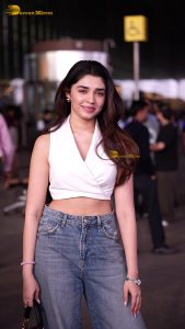 telugu actress Krithi Shetty cute in a white top and blue denim jeans